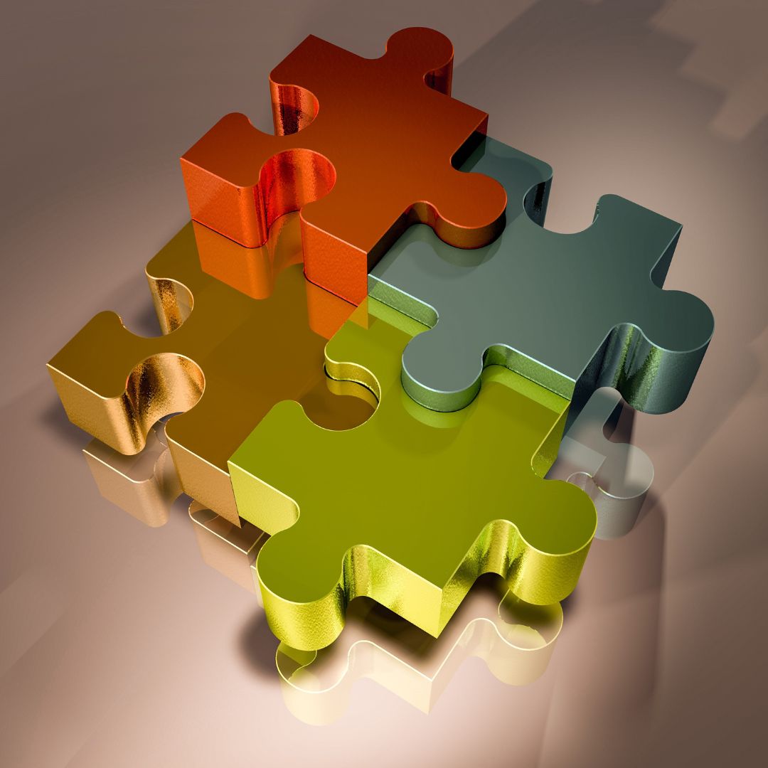 Four colourful puzzle pieces coming together, representing creative synergies